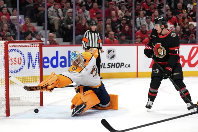 Nashville Predators goaltender Juuse Saros (74) makes a save on Ottawa Senators' Brady Tkachuk (7) during the second period of an NHL hockey game in Ottawa, Ontario, on Monday, Oct. 13, 2025. (Justin Tang/The Canadian Press via AP) Justin Tang/AP